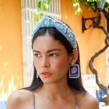 Load image into Gallery viewer, Trendy blue denim headband with decorative charms and sparkling details styled with statement earrings.