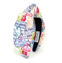 Load image into Gallery viewer, Lightweight printed headband featuring a playful travel motif with airport stamps, tickets, and airplane illustrations.