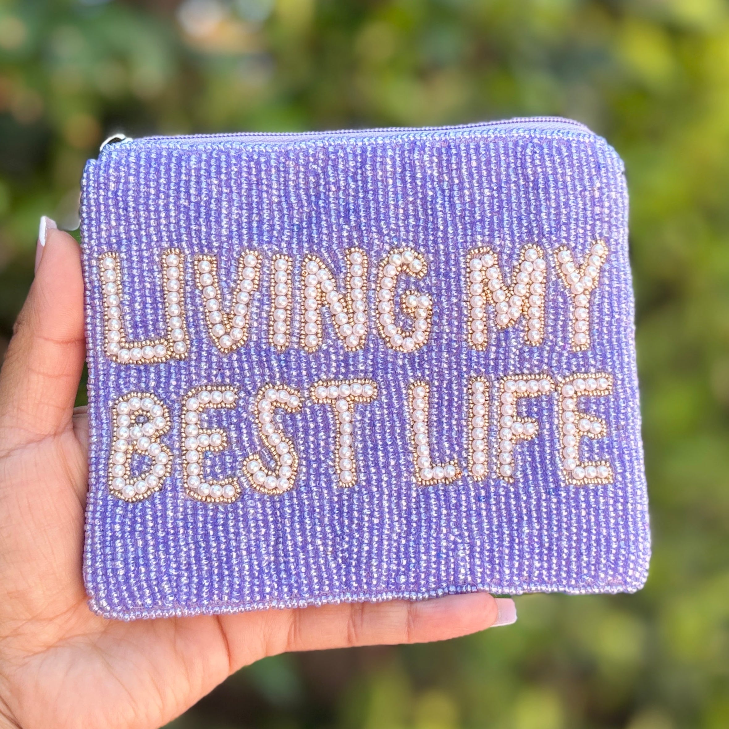 Purple hand-beaded zip wallet featuring inspirational typography