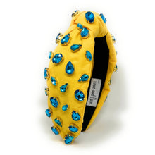 Load image into Gallery viewer, Elegant summer accessories styled with a yellow embellished headband and turquoise drop earrings in natural sunlight.