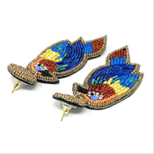 Load image into Gallery viewer, Stylish fashion portrait featuring a yellow embellished headband paired with tropical bird-inspired beaded drop earrings.