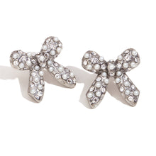 Load image into Gallery viewer, Bow-shaped earrings adorned with small pearls and crystals, set against a white background. They convey elegance and sparkle, suitable for formal occasions.