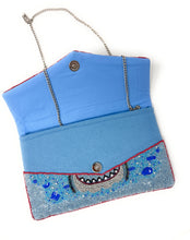 Load image into Gallery viewer, Coastal chic beaded clutch purse featuring a shark graphic design with textured blue bead embellishments.