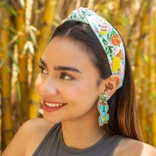 Load image into Gallery viewer, Whimsical hand embroidered earrings designed as aqua sunglasses with colorful beadwork and green gemstone details.