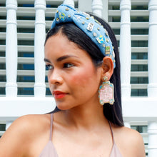 Load image into Gallery viewer, Pink suitcase-inspired statement earrings with sparkling embellishments and gold trim worn by a model.