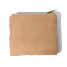 Load image into Gallery viewer, A small square canvas zippered pouch in a warm tan or light brown color, featuring a gold-tone zipper pull, shown on a plain white background with a soft shadow.