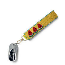 Load image into Gallery viewer, Hand beaded watermelon wristlet keychain featuring three colorful watermelon slices on a mustard yellow beaded strap with turquoise trim. Includes a gold-tone lobster clasp and soft wrist loop, perfect for carrying keys, key fobs, ID badges, or small accessories.