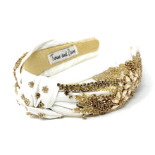 Load image into Gallery viewer, Elegant white headband adorned with gold embellishments.