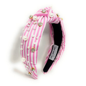 Pink and white striped headband with pearls and crystals on a white background