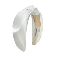 Load image into Gallery viewer, White headband with a label on a white background