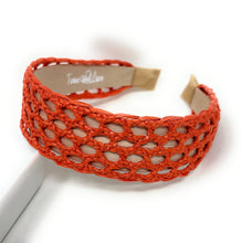 Load image into Gallery viewer, Vibrant orange woven headband with an open lattice design, featuring lightweight raffia-style texture and a comfortable padded lining.
