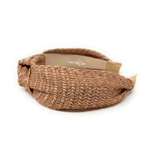 Load image into Gallery viewer, A woven straw headband in a natural tan color, featuring a knotted bow on one side and a padded elastic back band. The brand name 'Twine and Love' is visible on the inner paper label.