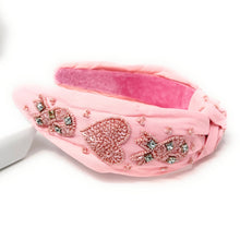 Load image into Gallery viewer, Soft pink padded headband with intricate beadwork, pearls, and a twisted knot design perfect for special occasions.