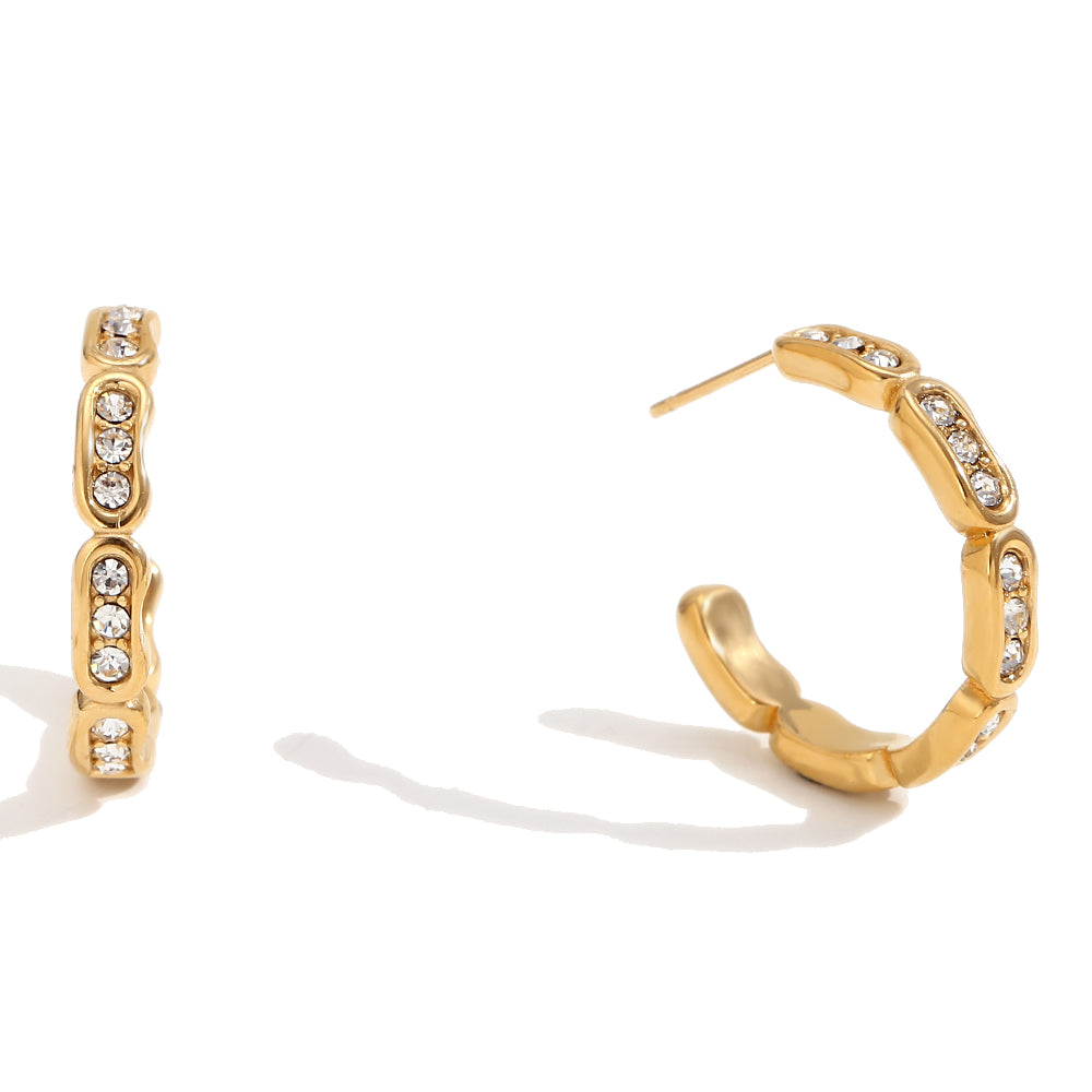 18k Gold hoop earrings with embedded crystals on a white background