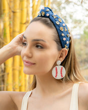 Load image into Gallery viewer, A model showcasing a blue headband with baseball-themed embellishments and baseball earrings.
