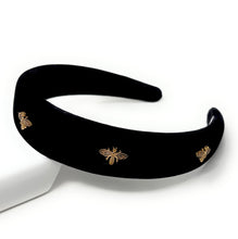Load image into Gallery viewer, A stylish black headband adorned with golden bee designs.