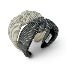 Load image into Gallery viewer, Two knotted fabric headbands with a polka dot pattern, one in cream and one in black, displayed on a clean white background.