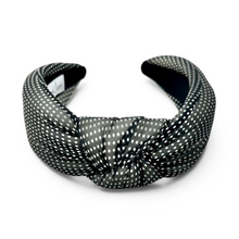Load image into Gallery viewer, A wide, padded headband with a knotted front detail, featuring a black and white polka dot pattern, shown on a plain white background.