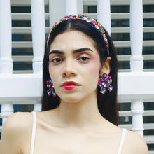 Load image into Gallery viewer, Close-up portrait of a fashion model with a colorful headband and earrings.