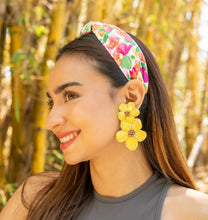 Load image into Gallery viewer, Stylish woman with a floral headband and yellow earrings posing against a bamboo backdrop
