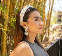Load image into Gallery viewer,  Elegant statement earrings worn by a model in a natural setting.