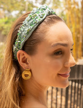 Load image into Gallery viewer, A close-up of a woman wearing an elegant green headband adorned with beads.