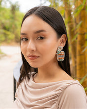 Load image into Gallery viewer, Close-up of a woman wearing stylish earrings in a natural setting.