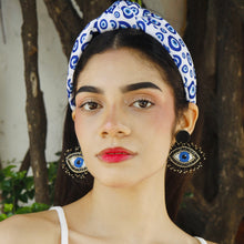 Load image into Gallery viewer, Portrait of a woman wearing eye-themed earrings and a patterned headband.