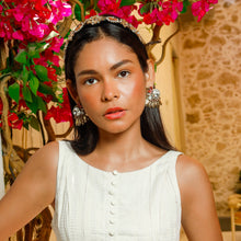 Load image into Gallery viewer, A fashionable woman posing in front of vibrant flowers, wearing a chic white outfit.