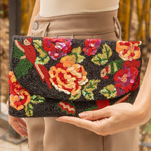 Load image into Gallery viewer,  Close-up of an embroidered clutch featuring colorful flowers and a bird design.