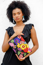 Load image into Gallery viewer, Black beaded evening clutch showcasing bright floral patterns in vivid shades of yellow, blue, red, pink, and purple.