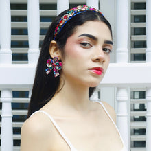 Load image into Gallery viewer, Close-up of a model wearing a stylish headband and vibrant earrings.