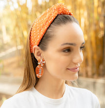 Load image into Gallery viewer, Close-up of a woman showcasing an orange headband and stylish earrings.