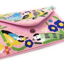 Load image into Gallery viewer,  A pink handbag adorned with intricate bird and flower patterns.