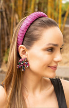 Load image into Gallery viewer, A woman wearing a pink sparkly headband and colorful flower-shaped earrings.