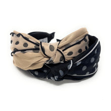 Load image into Gallery viewer, Two polka dot headbands, one beige with black dots and one black with white dots, on a white background.