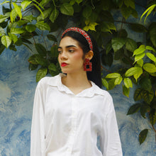 Load image into Gallery viewer, Close-up of elegant red earrings worn by a model in stylish attire.