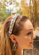 Load image into Gallery viewer, A close-up of a woman wearing a sparkling headband and colorful earrings in a natural setting.