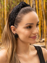 Load image into Gallery viewer, Fashionable black earrings worn by a model in a casual setting.