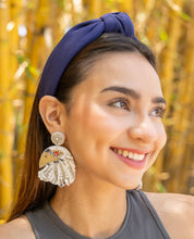 Load image into Gallery viewer, A cheerful woman with a navy hair accessory and decorative earrings, surrounded by bamboo.