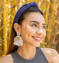 Load image into Gallery viewer, A cheerful woman with a navy hair accessory and decorative earrings, surrounded by bamboo.