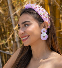 Load image into Gallery viewer, Close-up of trendy summer fashion accessories including a pink embellished headband and floral earrings on a smiling woman.
