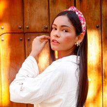 Load image into Gallery viewer, A stylish woman with a colorful headband posing against a wooden background.