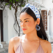 Load image into Gallery viewer, A fashionable woman wearing a pink dress and blue patterned headband outdoors.