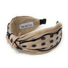Load image into Gallery viewer, Beige headband with black polka dots and knot design.
