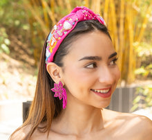 Load image into Gallery viewer, Close-up of a woman wearing stylish pink flower earrings, complementing her outfit.