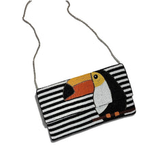 Load image into Gallery viewer, Hand-beaded toucan clutch worn as a crossbody bag with silver chain