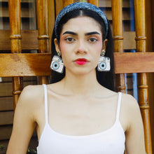 Load image into Gallery viewer,  A trendy fashion pose featuring a model with eye-catching camera earrings and a white top.