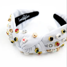 Load image into Gallery viewer, An embellished fabric headband featuring unique decorative elements.
