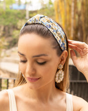 Load image into Gallery viewer, woman wearing a floral headband and statement earrings in a natural setting
